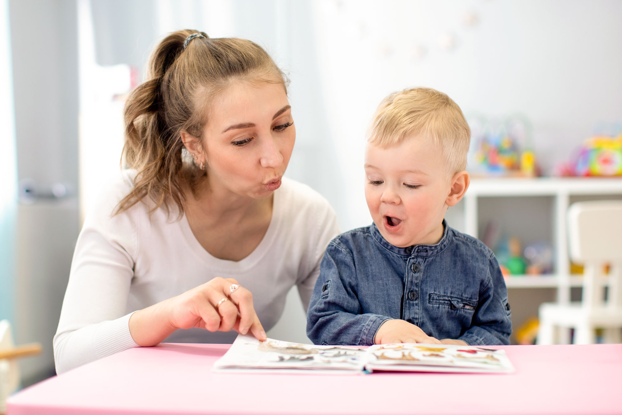 Female teacher helping children